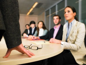 Businesspeople Listening to Manager in Meeting